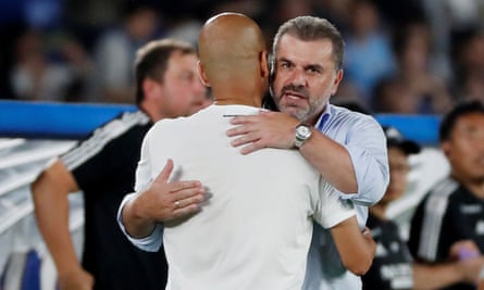 Yokohama’s manager, Ange Postecoglou, embraces Manchester City’s Pep Guardiola
