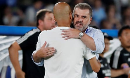 The Manchester City manager, Pep Guardiola, embraces Yokohama F Marinos manager Ange Postecoglou at the end of their 2019 friendly match
