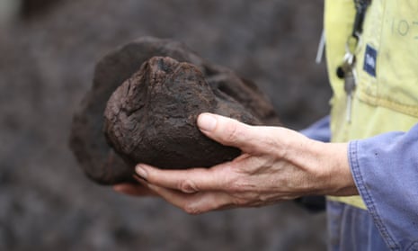 Man holds coal.