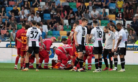Roma's Evan Ndicka receives medical assistance after collapsing on the pitch.