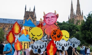 Protesters hold up placards as activists rally for climate action