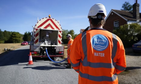 Workers from Thames Water delivering a temporary water supply from a tanker.