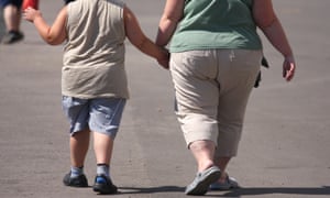 An overweight child and adult