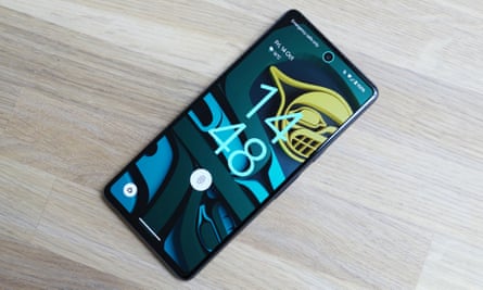 The Pixel 7 flat on a table showing the camera and fingerprint scanner are active.