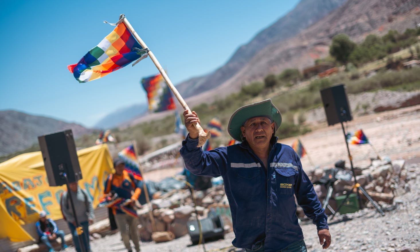 A man carries the Wiphala flag at the protest camp  in Purmamarca, Jujuy province.