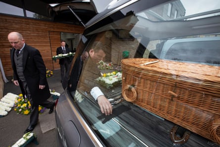 The funeral director Paul Brown along with funeral operatives Chris and Robert load Eddie’s wicker coffin into a hearse