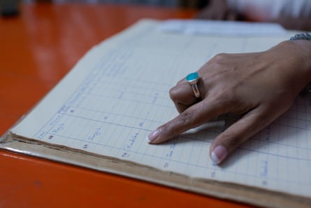 Jane looks for her name in the register book at the Mother Teresa Orphanage.