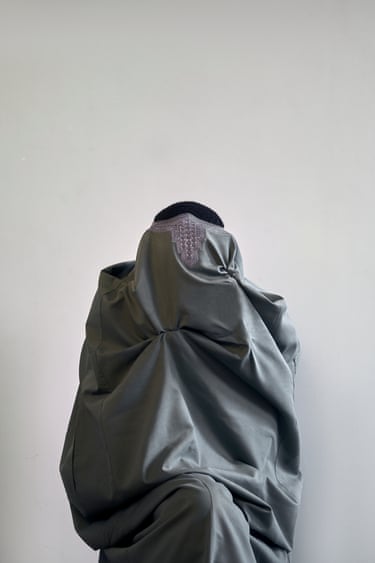 Worn light green jam-puut, GreyArea, 2022The jam-puut gathersaround the body untilgarment and figure becomealmost indistinguishable. Itselegance creates acommanding presence,while the concealed faceshifts attention towards thesilence and violence thatbeauty and authority can bemade to carry.