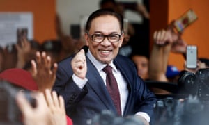 Malaysian politician Anwar Ibrahim gestures as he leaves a hospital where he was being treated while serving a prison sentence.