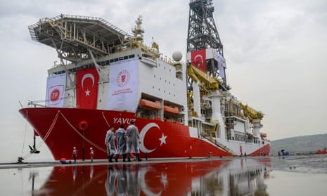 Turkish police officers patrol next to the Yavuz drillship, which was scheduled to search for oil and gas off Cyprus earlier this year.