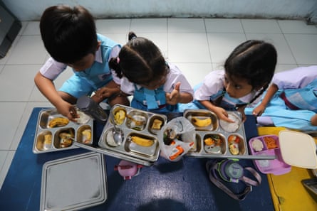 Indonesian students eat a free meal at a school in Keutapang, Aceh Besar, Indonesia, 29 September 2025.