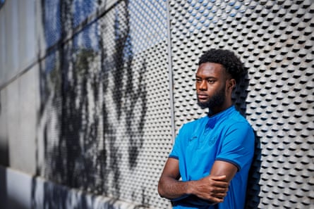 Abu Kamara leans against a fence during a photoshoot for the Guardian