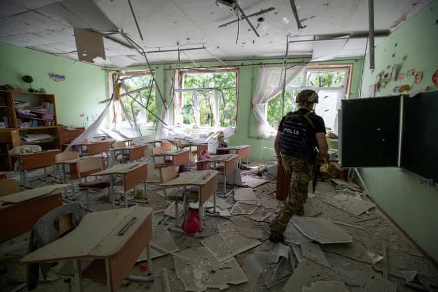 A police officer checking a school as residents were evacuated from Marinka in the Donetsk region on 31 May