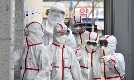 Medical staff in protective gear arrive for a shift at Dongsan hospital in Daegu, South Korea.