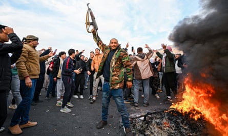 People celebrate at Umayyad Square in Damascus after Islamist-led rebels declared that they had taken the Syrian capital.