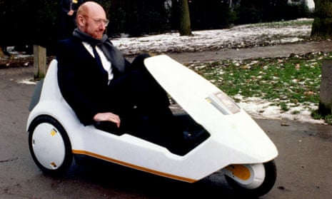 Sir Clive Sinclair demonstrating his C5 battery-pedal-powered trike at Alexandra Palace in London circa 1985.