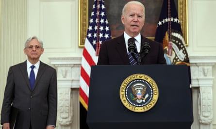 President Joe Biden speaks on gun crime prevention measures as attorney general Merrick Garland looks on.