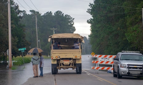 The South Carolina national guard assists residents evacuating from rising flood waters during Hurricane Florence. Flooding from the storm is expected to hit Georgetown this week.