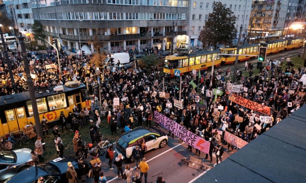 Protesters block a street in Warsaw on Monday