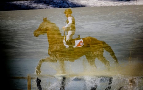 Robin Godel of Switzerland on Grandeur Du Lully reflected in the Menagerie Pond during the Olympics eventing cross-country at the Palace of Versailles