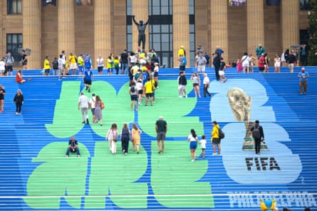 Brazilian and other football fans climb the steps leading to the Rocky statue, marked with a Fifa World Cup logo, in Philadelphia