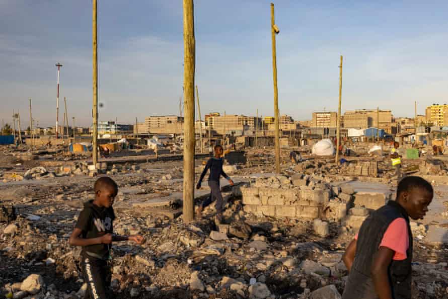 Boys walk through the rubble in Mukuru Kwa Njenga