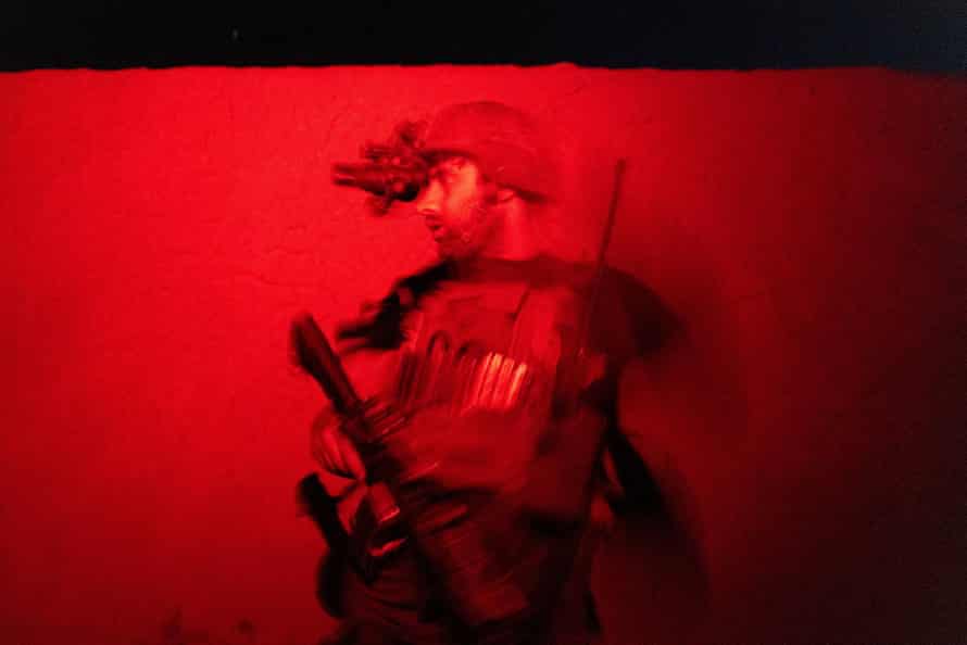 A member of the Afghan Special Forces keeps a watch as others search a house during a combat mission against Taliban, in Kandahar province, Afghanistan, July 12, 2021