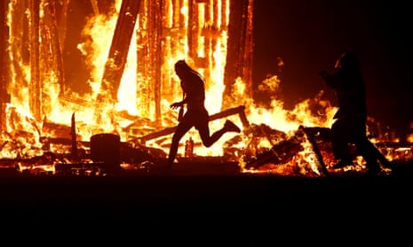Burning Man participant runs into the flames.