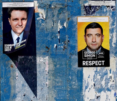 A billboard displays electoral posters of the candidates for the 2025 presidential election runoff, in Bucharest, Romania.