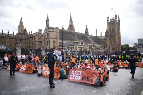Just Stop Oil protesters blocking the road outside parliament.