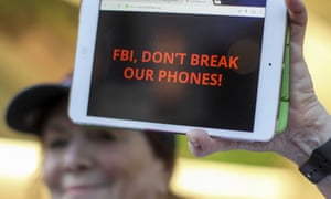 A demonstrator holds up her iPad during a rally in support of data privacy in Los Angeles, 23 Feb 2016.
