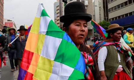 A supporter of the former Bolivian president Evo Morales holding a Wiphala flag takes part in a protest, in La Paz, Bolivia, on Thursday.