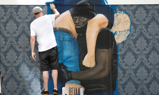 Street artist Lionel Stanhope painting a mural depicting Patrick Hutchinson in Lewisham, south London, in August.