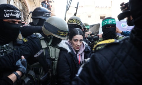 Members of Islamic Jihad and Hamas fighters escort Arbel Yehoud