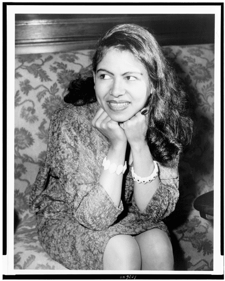 portrait of woman looking to side with hands on chin