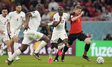 Belgium's Kevin De Bruyne, (right) runs with the ball and is pursued by Canada players.