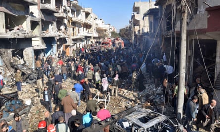 Syrians gather at the scene of a car bomb attack in Homs on 12 December.
