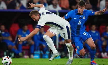 Harry Kane tries to evadeJaka Bijol of Slovenia.