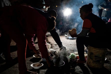 Asylum seekers from Guerrero State eat at their campsite in Ciudad Juárez, Mexico, in December 2019.