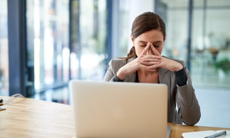 woman looking anxious at a laptop