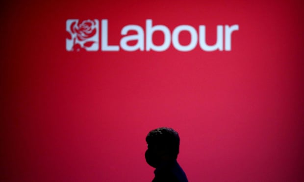 A person walks past the logo of Britain's Labour party during their annual conference in Brighton last year.