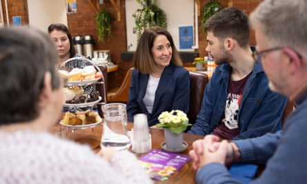 Liz Kendall sitting at a table talking to people