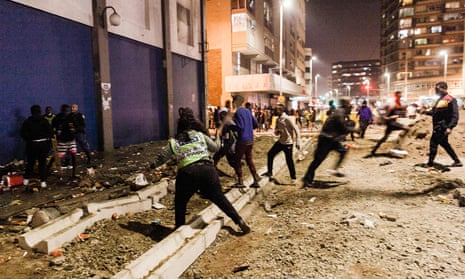 Police officers tackle looters in central Durban, South Africa.
