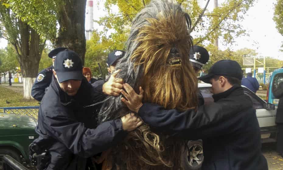 Policemen detain a person dressed as Star Wars character Chewbacca during a regional election near a polling station in Odessa, Ukraine.