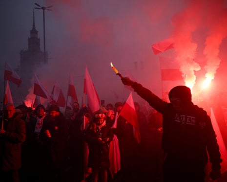 People use flares as they gather for a march to mark the 107th anniversary of Polish independence, in Warsaw, Poland.