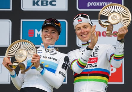 Demi Vollering and Tadej Pogacar pose on the podium after winning the women’s and men’s Tour of Flanders.
