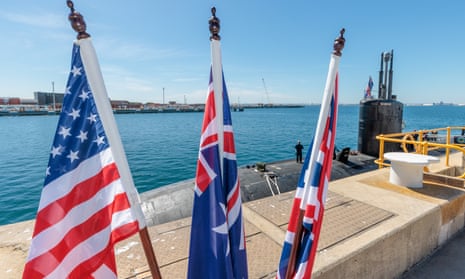 The US, Australian and British are seen in front of the USS Asheville, a Los Angeles-class nuclear powered fast attack submarine, at HMAS Stirling, Western Australia on Tuesday.