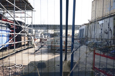 Scaffolding yard photographed from behind fence
