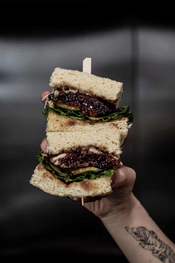 An ‘iso sando’ made with shokupan, karaage, black Korean sauce, cos, cucumber, onion cream and garlic chips, served by Melbourne’s Hibiki cafe.