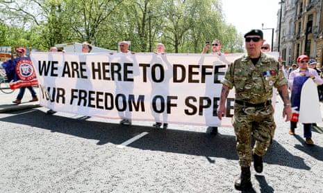 Protesters march with a free-speech banner in London